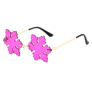 Quirky gold-framed rimless party sunglasses with snowflake-shaped rose pink lenses