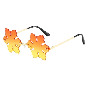 Quirky maple leaf shaped sunglasses with orange gradient lenses and gold metal frames