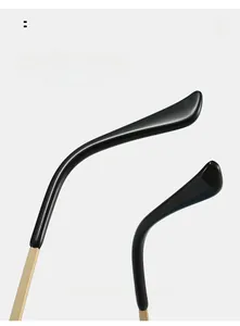 Detail of ergonomic curved eyewear temples with black acetate and gold metal finish