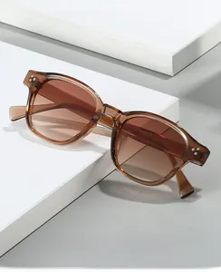 Detail of stylish tea-colored frame sunglasses with gradient lenses and metal accents
