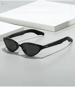 Detailed close-up of retro cat-eye sunglasses featuring silver metal rivets on black frames