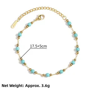 Detail of gold chain bracelet with blue beads, lobster clasp and S-STEEL tag
