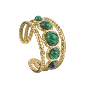 Detail of gold twisted rope band ring featuring five inlaid green malachite stones