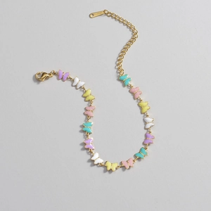 Minimalist gold stainless steel bracelet featuring colorful enamel butterfly charms