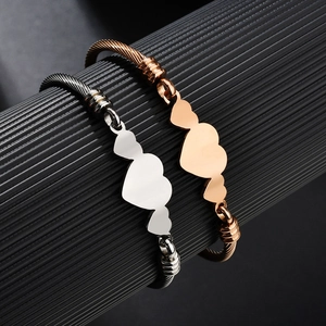 Elegant stainless steel cable bracelets with three heart charms in rose gold and silver