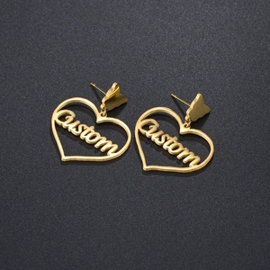 Golden heart earrings with butterfly studs and custom letter pendant in minimalist style