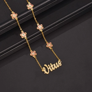 Golden necklace with Vitus diamond pendant and floral accents on black background
