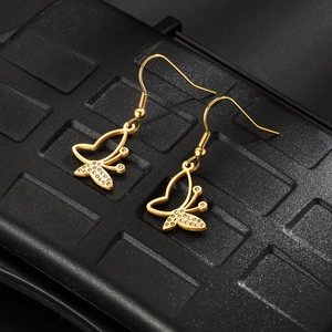 Elegant gold butterfly drop earrings with sparkling crystal pavé and hollow frame design