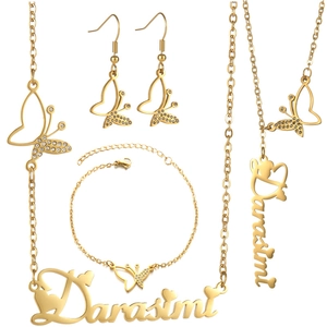 Detail of gold butterfly jewelry set including name necklace, bracelet and earrings