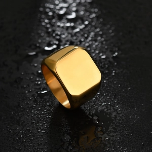 Polished gold square signet ring in stainless steel for engraving on black stone surface