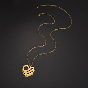 Golden heart pendant necklace with three miniature gemstones on a fine link chain