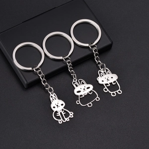 Three minimalist rabbit keychains in polished stainless steel with hollow outlines