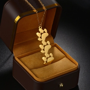 Golden stainless steel bear paw pendant necklace displayed in a premium velvet gift box