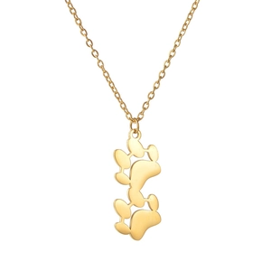 Detail of a polished gold-plated double bear paw print pendant on a fine O-chain necklace