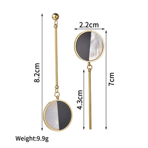 Asymmetric circular dangle earrings with black and white shell pendants in gold plating