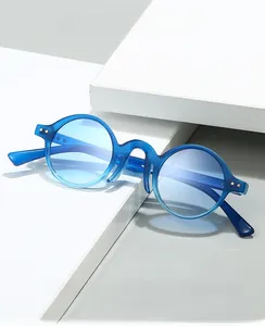 Detail view of round blue sunglasses on geometric stands with clear resin frames