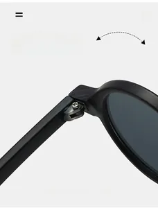 Close-up of durable metal hinges on round black frame sunglasses with precise screw details