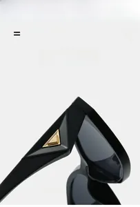 Gros plan détaillé de lunettes de soleil œil-de-chat noires avec détails triangles dorés