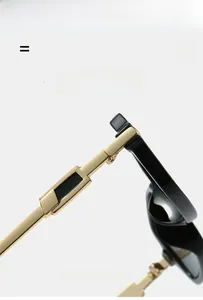 Macro detail of gold metal temples with geometric block design on black sunglasses