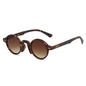 Retro round tortoise shell sunglasses with tea gradient lenses and metal rivet details
