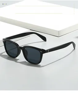 Detailed close-up of premium black square frames with silver rivet accents and grey lenses