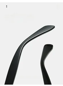 Detail of glossy black sunglasses legs featuring a sleek curved design and smooth finish