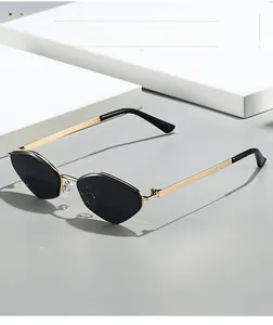 Macro detail of geometric gold metal sunglasses frame with dark polarized lenses