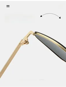 Detail of durable gold metal frame hinge and dark grey lens on stylish sunglasses