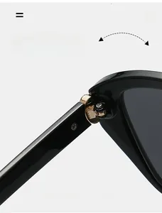 Macro detail of a durable golden metal hinge on black cat-eye sunglasses for women