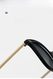 Detailed close-up of lightweight gold woven textured metal temple on black sunglasses
