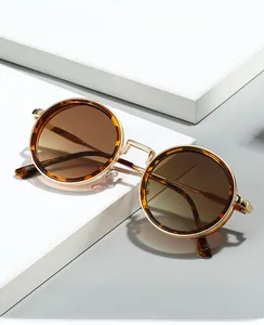 Detail of retro round glasses with gold metal frames and tortoise shell accents