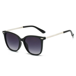 Fashionable oversized square sunglasses with black frames and gold woven temples