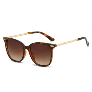 Classic tortoise shell square sunglasses with golden braided metal temples on white background