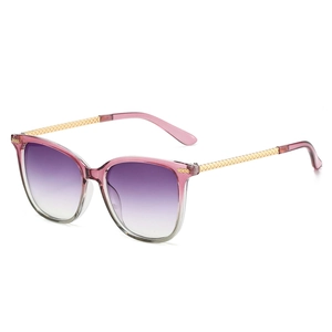 Cat eye sunglasses with purple gradient lenses and gold woven metal temples on white background