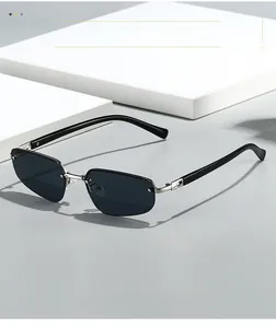 Detail shot of rimless narrow sunglasses with dark lenses on a white geometric stand