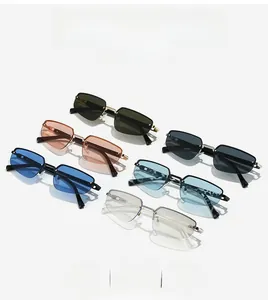 Detailed flat lay of colorful rimless sunglasses in multiple lens shades with metal frames