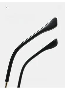Detail of curved ergonomic temples on black fashion sunglasses for comfortable wear