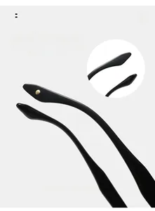 Detail of glossy black curved temple legs with a stylish golden rivet on sunglasses
