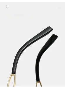 Detail of ergonomic curved black mirror legs with golden metal hinge for comfort