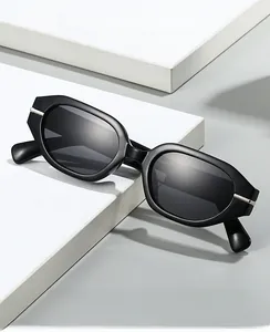 Close-up of irregular oval black sunglasses with silver metal accents on geometric stands