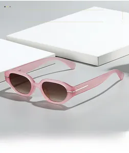 Detail of pink translucent sunglasses with gradient lenses and silver T-shaped metal decor