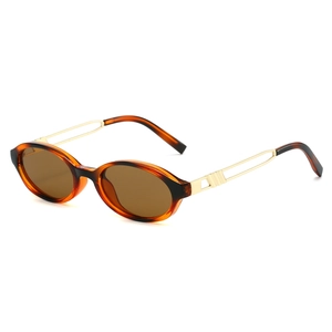 Retro oval tortoiseshell sunglasses with hollow gold metal temples and clear lenses