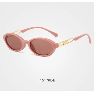 Detail of pink oval sunglasses with gold metal temples and grooved openwork accents