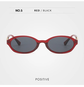 Front view of retro oval sunglasses with transparent red frames and metal hinge detail