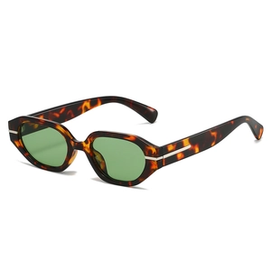 Irregular tortoise shell sunglasses with green lenses and silver metal detail
