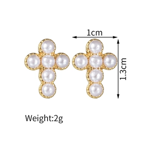 Detailed view of cross earrings with dimensions 1.0x1.3cm and 2g weight specs