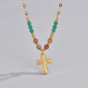 Detailed macro view of a gold star pendant necklace with assorted colorful beads