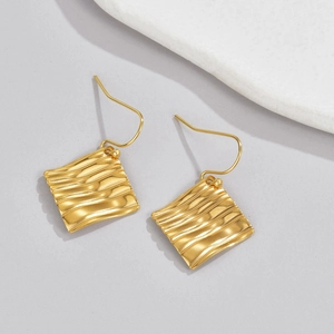 Minimalist square earrings with 18K gold textured wave pattern on light grey background