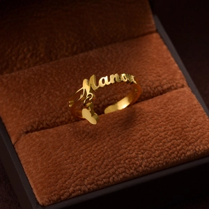 Custom gold stainless steel Manou name ring with a heart pendant in a jewelry box