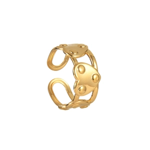 Detailed close-up of golden heart ring featuring relief dotted pattern on band